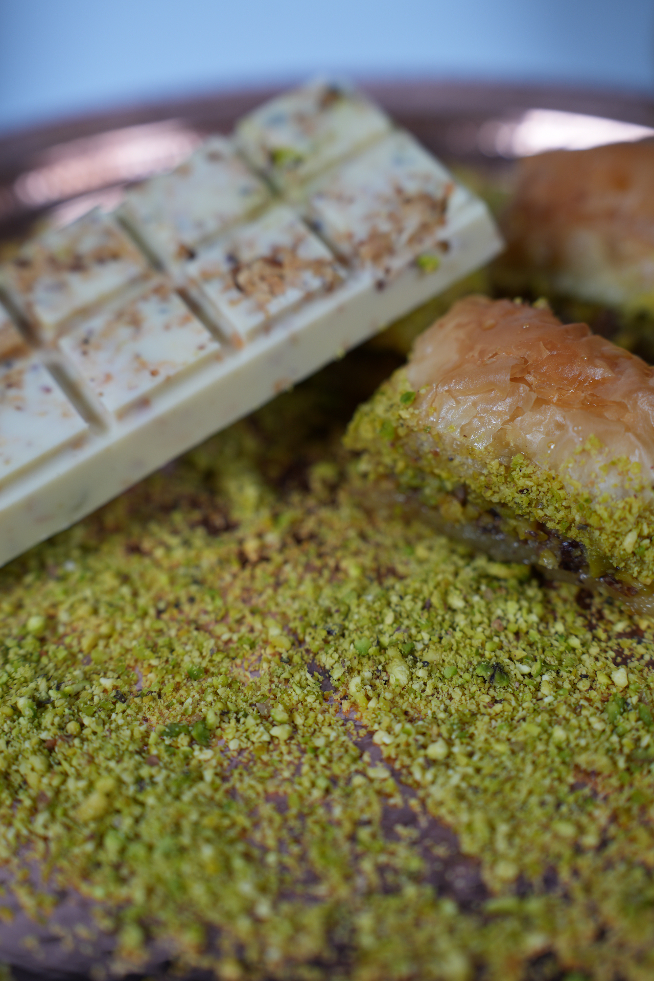 Bright green pistachios on a wooden board